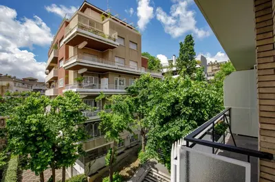 an apartment building with trees in front of it at Pio Vatican Flat in Rome