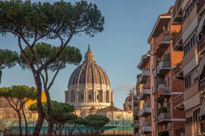 a building with a dome in the background with buildings at Pio Vatican Flat in Rome