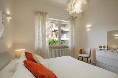 a bedroom with a white bed and a window at Pio Vatican Flat in Rome
