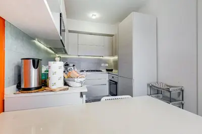 a kitchen with white cabinets and a white counter top at Valle Aurelia Vatican Home - Beutiful View & Wi-Fi in Rome