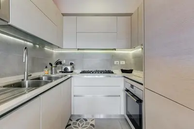 a kitchen with white cabinets and a sink at Valle Aurelia Vatican Home - Beutiful View & Wi-Fi in Rome