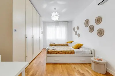 a white bedroom with a bed and white cabinets at Valle Aurelia Vatican Home - Beutiful View & Wi-Fi in Rome
