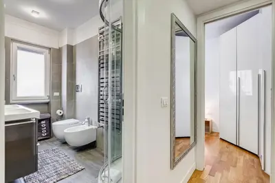 a bathroom with a toilet and a sink and a mirror at Valle Aurelia Vatican Home - Beutiful View & Wi-Fi in Rome
