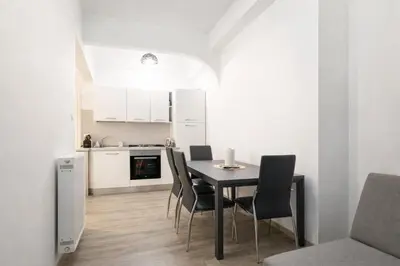 a kitchen and dining room with a table and chairs at Central Rome 2BR Walk to Vatican & Piazza Navona in Rome