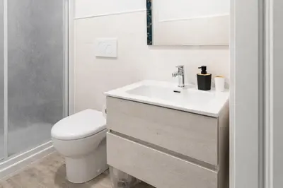 a white bathroom with a sink and a toilet at Central Rome 2BR Walk to Vatican & Piazza Navona in Rome