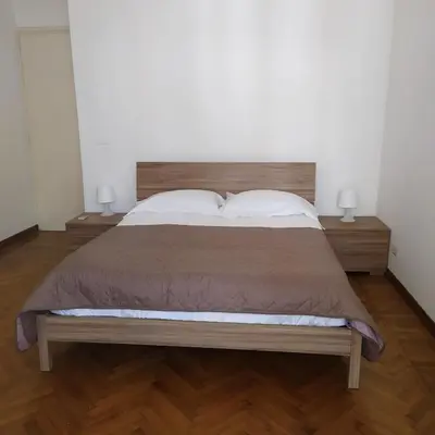 a bedroom with a large bed with two pillows at Morosini House Rome in Rome