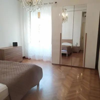 a room with a mirror and a bed and a bedroom at Morosini House Rome in Rome