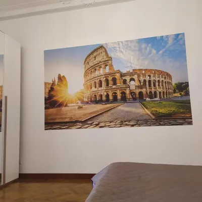 a picture of the colosseum on a wall in an art exhibit at Morosini House Rome in Rome