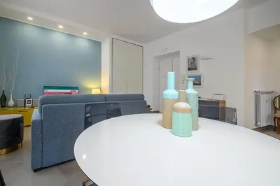 a living room with a table with bottles on it at D'Aquino Apartment St. Peter's in Rome