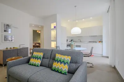 a living room with a couch and a kitchen at D'Aquino Apartment St. Peter's in Rome