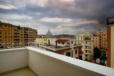 a view of a city from a balcony at D'Aquino Apartment St. Peter's in Rome