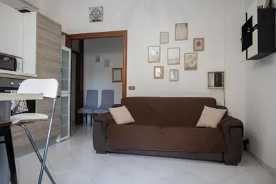 a living room with a brown couch and a table at Cerroni's Corner in Rome