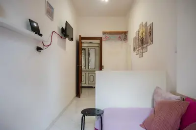 a living room with a couch and a door at Cerroni's Corner in Rome