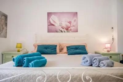 a bedroom with a bed with blue towels on it at Cerroni's Corner in Rome