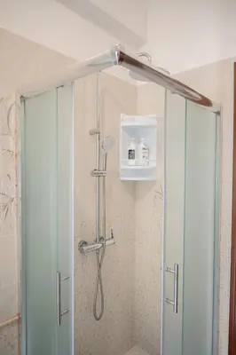 a shower with a glass door in a bathroom at Cerroni's Corner in Rome