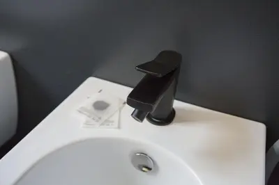 a black faucet on a toilet in a bathroom at Appartamento Roman Feelings in Rome
