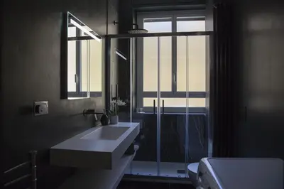 a bathroom with a sink and a mirror and a window at Appartamento Roman Feelings in Rome