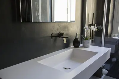 a white sink in a bathroom with a mirror at Appartamento Roman Feelings in Rome