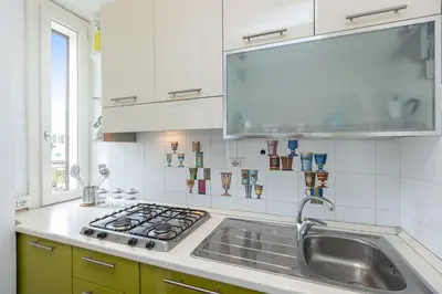 a kitchen with a sink and a stove at Tasso by Rental in Rome in Rome