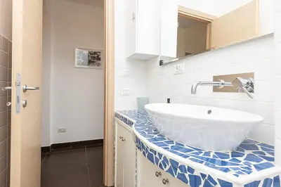 a bathroom with a white sink and a counter at Tasso by Rental in Rome in Rome