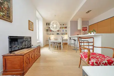 a living room with a fireplace and a dining room at San Pietro Al Vaticano by Halldis in Rome