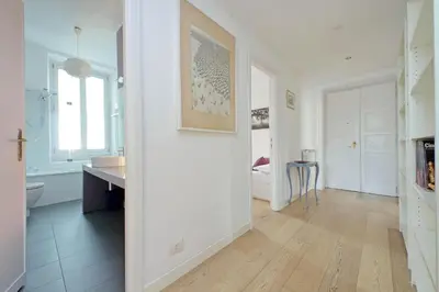 a kitchen with white walls and a wooden floor at San Pietro Al Vaticano by Halldis in Rome