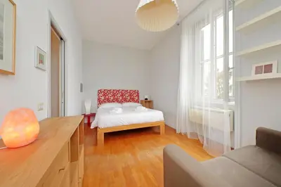 a white room with a bed and a chair at San Pietro Al Vaticano by Halldis in Rome