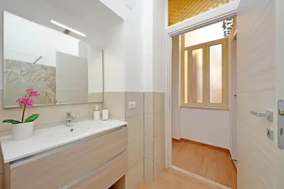 a bathroom with a sink and a mirror at Julius House in Rome