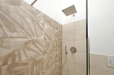 a bathroom with a shower with a glass door at Julius House in Rome