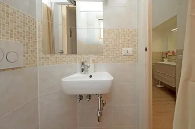 a bathroom with a sink and a mirror at Julius House in Rome