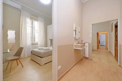 a bedroom with a bed and a desk and a mirror at Julius House in Rome