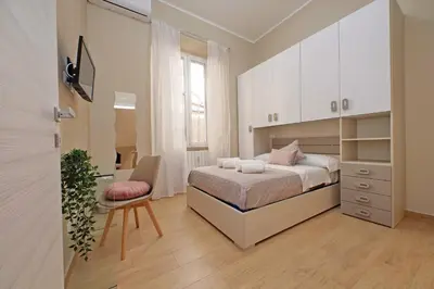 a bedroom with a bed and a desk and a chair at Julius House in Rome