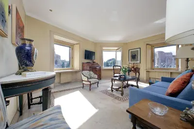 a living room with a blue couch and a fireplace at Colosseo Way in Rome