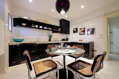 a kitchen with a table and chairs in a room at Colosseo Way in Rome