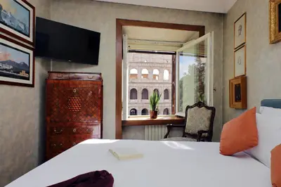 a hotel room with a bed and a window at Colosseo Way in Rome