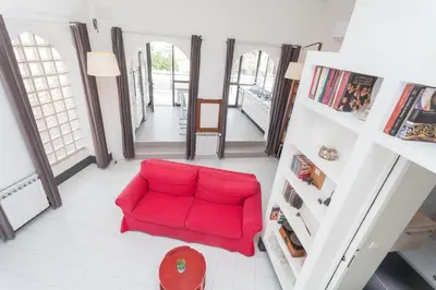 a red couch sitting in a living room at Prati Belfiore Guesthouse in Rome