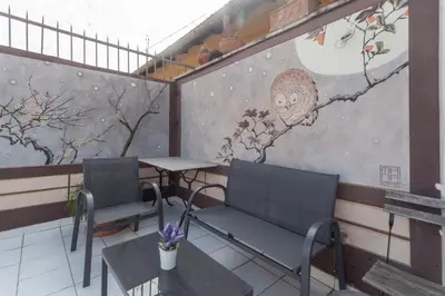 a patio with two chairs and a table and a mural at Prati Belfiore Guesthouse in Rome