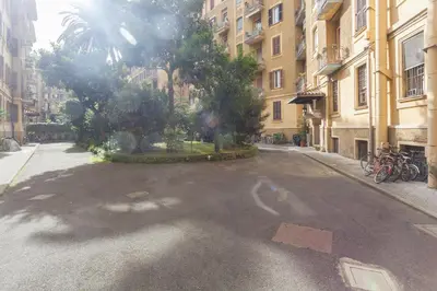 an empty street with trees and buildings in a city at Prati Belfiore Guesthouse in Rome