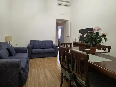 a living room with a table and a blue couch at Be Your Home - MR House in Rome