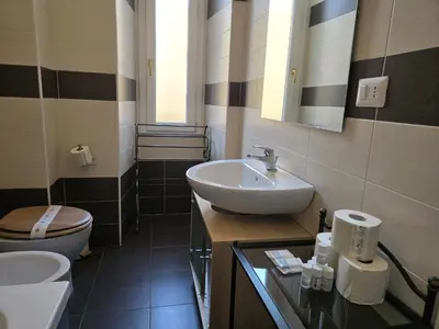 a bathroom with a sink and a toilet at Be Your Home - MR House in Rome