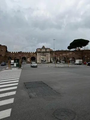 a brick building with a car parked in a parking lot at Be Your Home - MR House in Rome