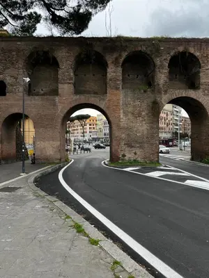 an old brick bridge with arches on a road at Be Your Home - MR House in Rome