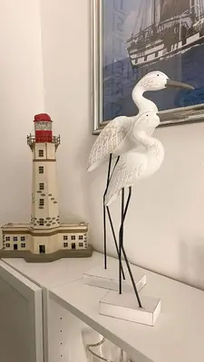 a statue of two birds on a shelf with a lighthouse at Three sisters- La casa nel Cuore di Roma in Rome