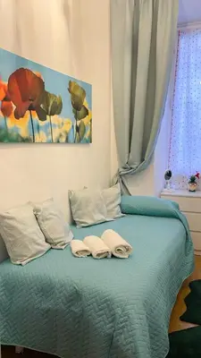 a bedroom with a bed with two towels on it at Three sisters- La casa nel Cuore di Roma in Rome