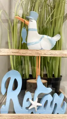 a figurine of a bird sitting on a wooden shelf at Three sisters- La casa nel Cuore di Roma in Rome