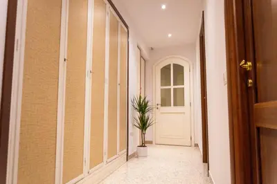 a hallway with a white door and a potted plant at TESTACCIO XIX-XXV Bed & Breakfast in Rome