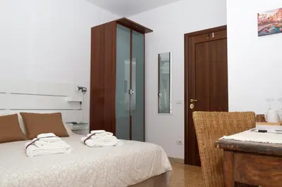 a bedroom with a bed with two towels on it at TESTACCIO XIX-XXV Bed & Breakfast in Rome