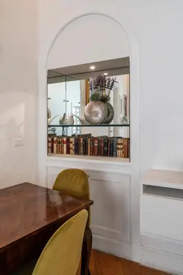 a dining room with a table and a shelf with books at Star Beauty House in Rome