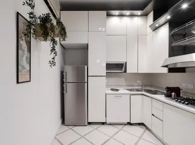 a kitchen with white cabinets and a stainless steel refrigerator at Star Beauty House in Rome