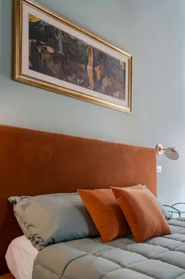 a couch with pillows sitting under a painting on the wall at Star Beauty House in Rome